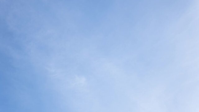 White clouds moving fast from right to left time-lapse. Daylight cloudy heaven background. Long timelapse light clouds transforming in blue sky with motion blur. Perfect for text, titles, logo