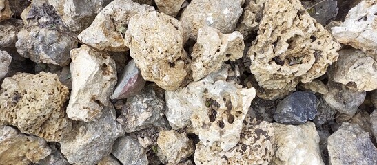 The retaining wall is made of natural stones. Horizontal photography