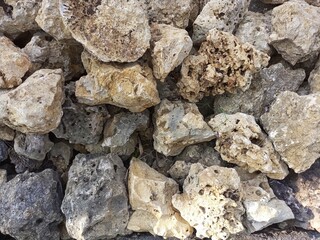 The retaining wall is made of natural stones. Horizontal photography