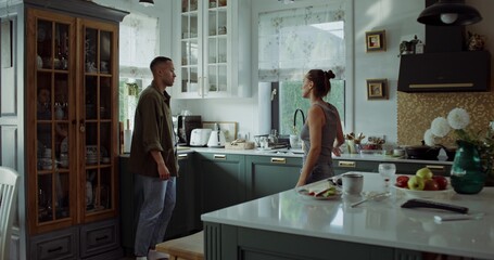Husband and wife are fighting at home. They start laughing during an argument