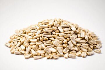 A pile of sunflower seeds on a white surface, great for photography and illustration purposes