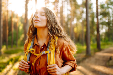 Portrait of young woman walking in the forest.  Enjoying fresh air Travelling, lifestyle, adventure