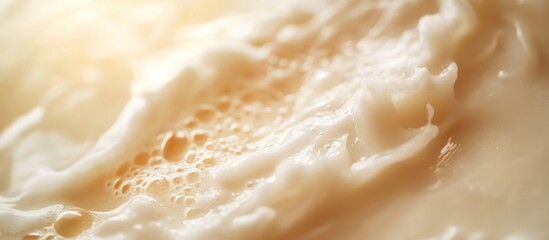 Obraz premium Creamy milk foam texture close-up, sunlit backdrop, dairy product advertisement