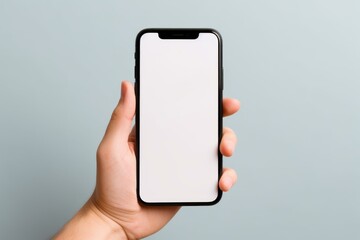 Close up of a hand holding a modern smartphone with blank white screen, perfect for showcasing mobile apps or websites
