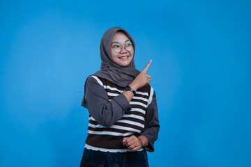 Woman pointing upwards with a happy expression