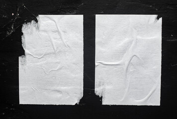 Two white posters on a black background.