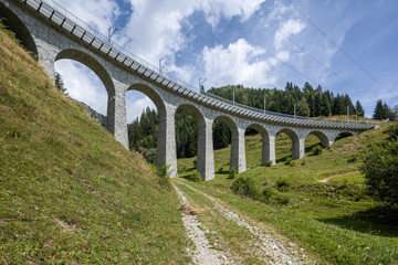 Fototapeta premium Railroad bridge in Tujetsch, so many beautiful stone bridges.