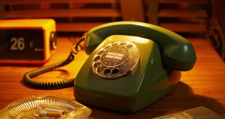A wired phone is on the desk in the office. Details of the retro interior. Camera zoom