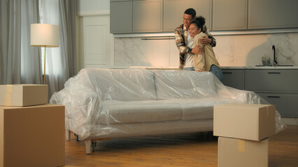 Happy male female home owners African American family moving in new house relocation cheerful woman...