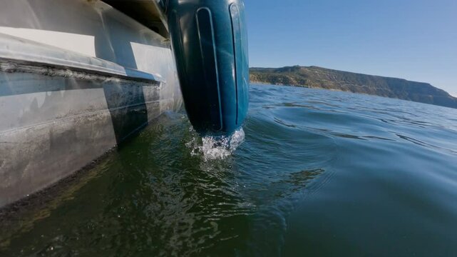Boat Bumper Buoy On Side of Pontoon Boat as It Drives