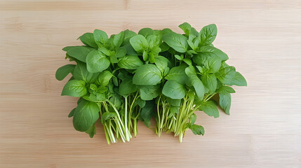 Fresh basil sprigs on wooden board, overhead shot, for cooking recipes
