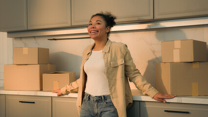 Happy smiling woman African American girl cheerful homeowner renter tenant moving in new own home...