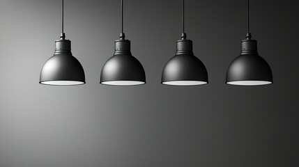 Obraz premium Four Black Pendant Lights Hang Against Dark Gray Wall