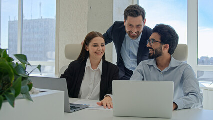 Three happy business people creative team coworkers smiling businessmen businesswoman working...