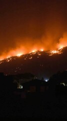 Obraz premium Nighttime Inferno on the Hillside