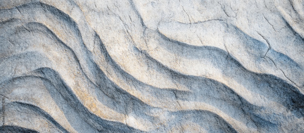 Poster Textured stone surface with wave-like patterns in neutral tones for background usage with Copy Space.