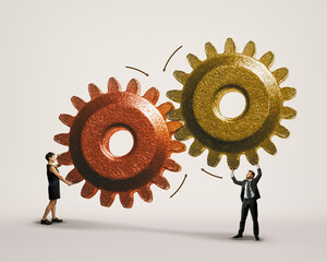 The man and woman are connecting large gears as a metaphor for interaction and teamwork. Art...
