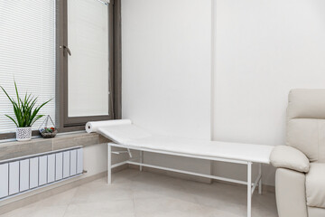 View of modern medical office with doctor's workplace in clinic. Modern medical office with doctor's workplace and examination table in clinic