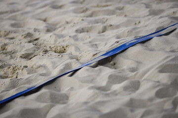 Indoor Beach Volleyball Game Court Blue side line with sand. Photo taken in indoor arena.