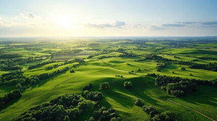 Obraz premium Aerial view of rolling green hills at sunset