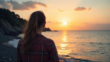 Fototapeta premium Thoughtful Woman Enjoying a Picturesque Sunset While Standing by the Calm Sea Shoreline