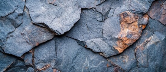 Natural stone wall texture with irregular gray and brown patterns