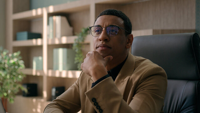 Close up thoughtful male businessman puzzled ethnic man think difficult question business problem solution at office workplace pensive employer manager CEO thinking ponder deep thoughts consider doubt
