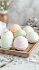 Herbal bath bombs in pastel shades placed on a wooden tray. pic
