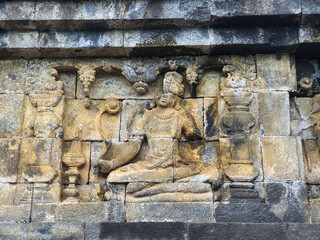 Borobudur Temple, Magelang. Ancient Stone Reliefs carving Depict Serene Buddha Figures and Narrative Scenes at Historic Temple, Masterful Carving Techniques and Spiritual Significance