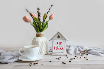 Calendar for March 15: numbers 15, name of the month March in English, bouquet of tulips, white cup
