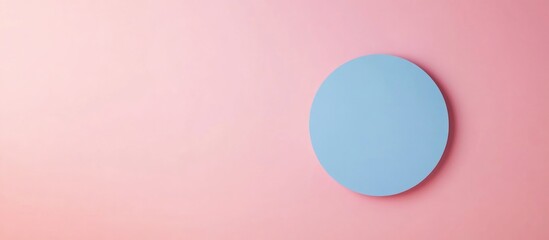 Minimalist blue circular object on pink background with smooth gradient Copy Space