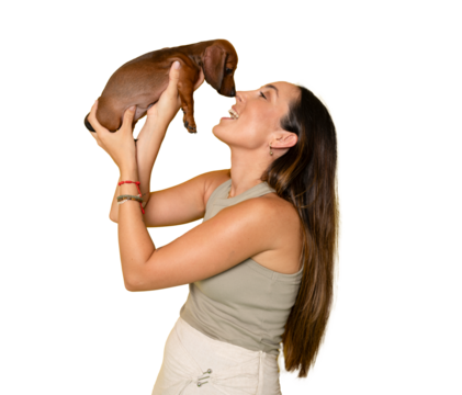 Cute young woman kisses and hugs her puppy dachshund dog. Love between owner and dog. Isolated on transparent background. PNG transparent.