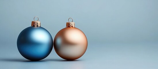 Blue and gold Christmas ornaments on a light background with copy space for text