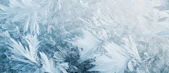 Frosty natural ice patterns with intricate details on a cold surface in shades of blue and white Copy Space