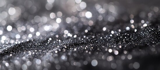 Black and silver glitter background with bokeh effect shallow depth of field and copy space for text