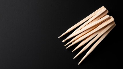 Wooden skewers on black background, food prep