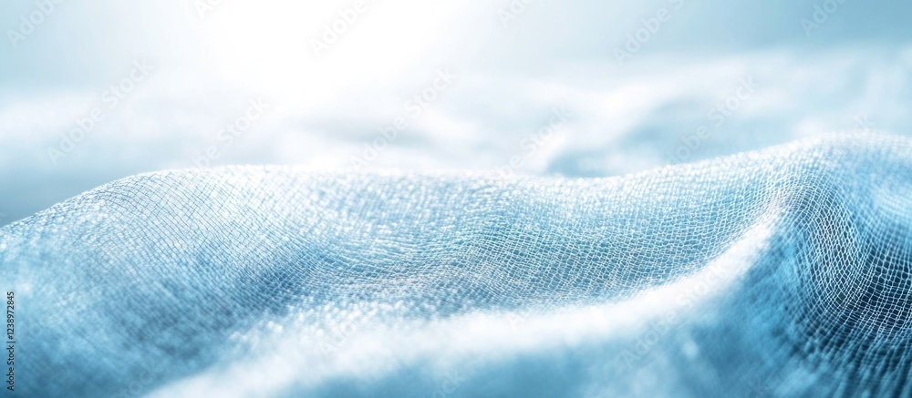 Aufkleber Soft blue fabric draped in gentle waves with a luminous bright background and shallow depth of field Copy Space