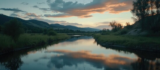 Tranquil river landscape at dusk with reflections of clouds and mountains in still water Copy Space