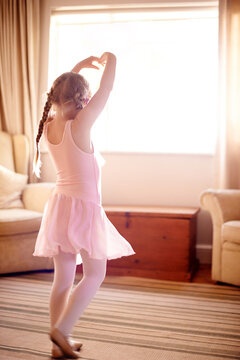 House, ballet and girl with energy, dancing and growth with pink tutu, learning and practice. Apartment, ballerina or kid with costume, training for performance or creativity with movement or routine