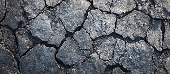 Fototapeta premium Cracked asphalt texture background showing dry and broken surface with copy space for text addition
