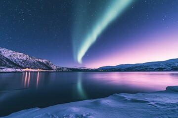 Fototapeta premium Aurora borealis over a calm lake with snow covered mountains and a starry night sky