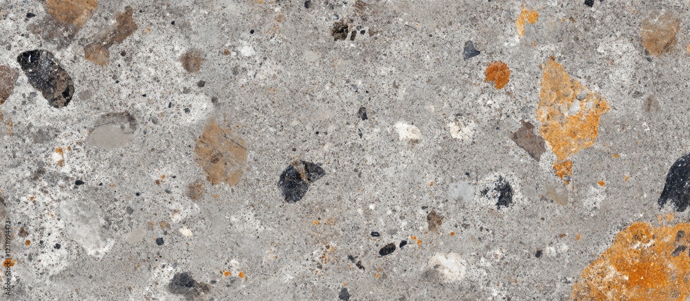 Poster textured natural stone wall surface with various colored mineral inclusions and copy space for desig