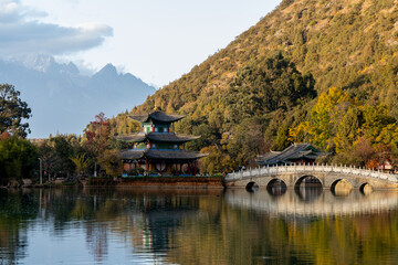 Scenic View of Jade Dragon Snow Mountain and Black Dragon Pool with Suocui Bridge and Moon Embracing Pavilion, Lijiang, Yunnan, China
