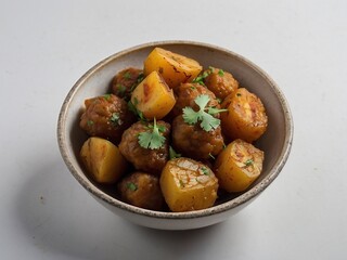 Aloo Gobi Roasted Potatoes with Spices and Fresh Herbs in a Bowl Comfortable Vegetarian Side Dish