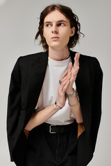 A stylish young man embodies confidence in a chic, minimalist setting.