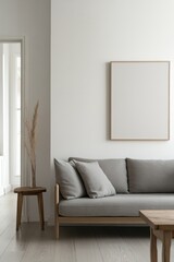 Minimalist living room with gray sofa, wooden frame, and pampas grass.