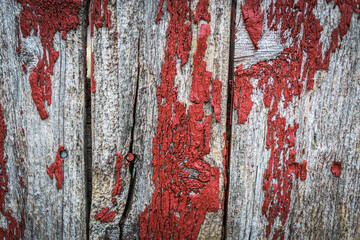 close-up of old red peeling paint country farm texture blank fence background