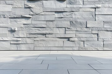 Weathered gray stone wall with intricate details and smooth tile floor, blending rustic and modern aesthetics seamlessly