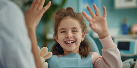 Happy girl smiling and giving high five to dentist after checkup