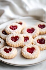 Heart shaped linzer cookies with raspberry jam and powdered sugar on plate